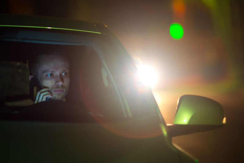 man checking the car at the back