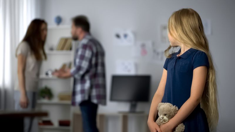 young child watching parents argue in the next room